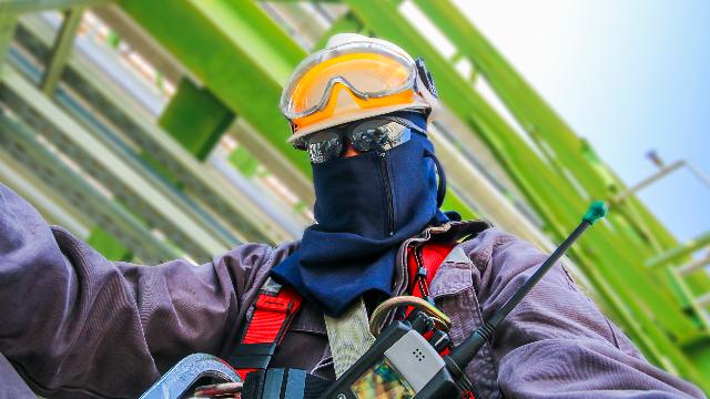 Worker wearing hard hat, safety glasses and respirator during PPE training