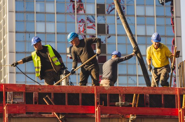 Construction workers in hard hats on a building site — weekly safety news update